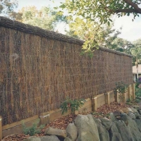 brushwood-fence-with-rock-wall